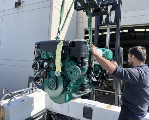 Marine engine being lowered into a boat.