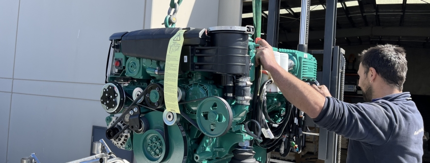 Marine engine being lowered into a boat.