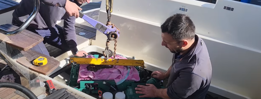 New marine engine being lowered into a boat.