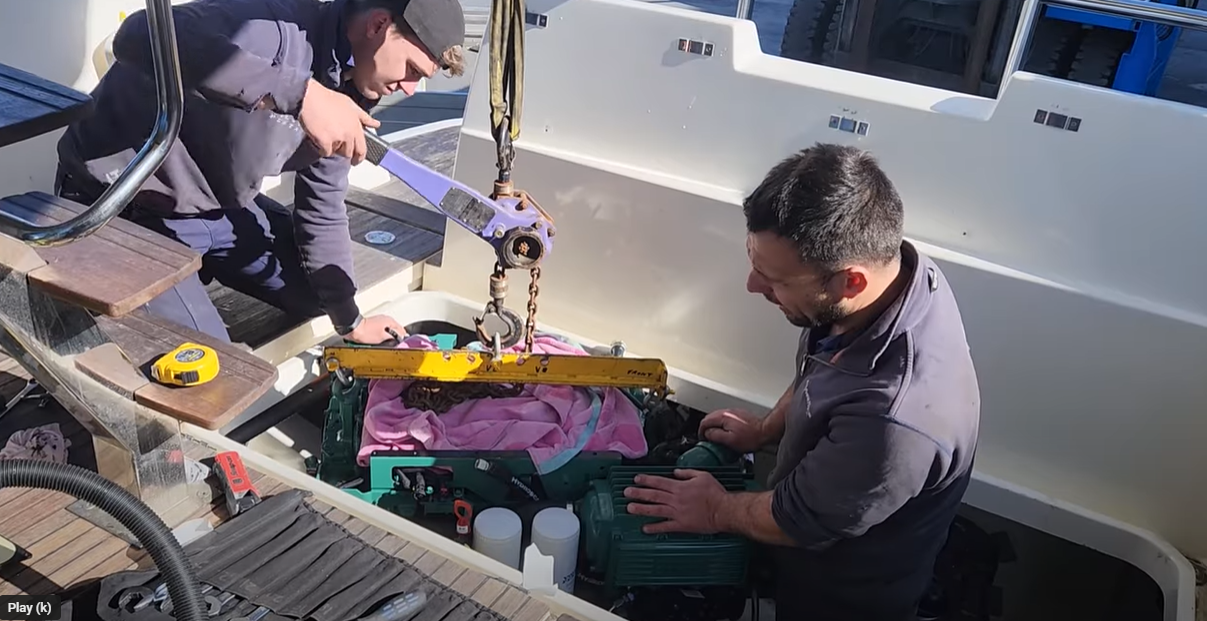 New marine engine being lowered into a boat.